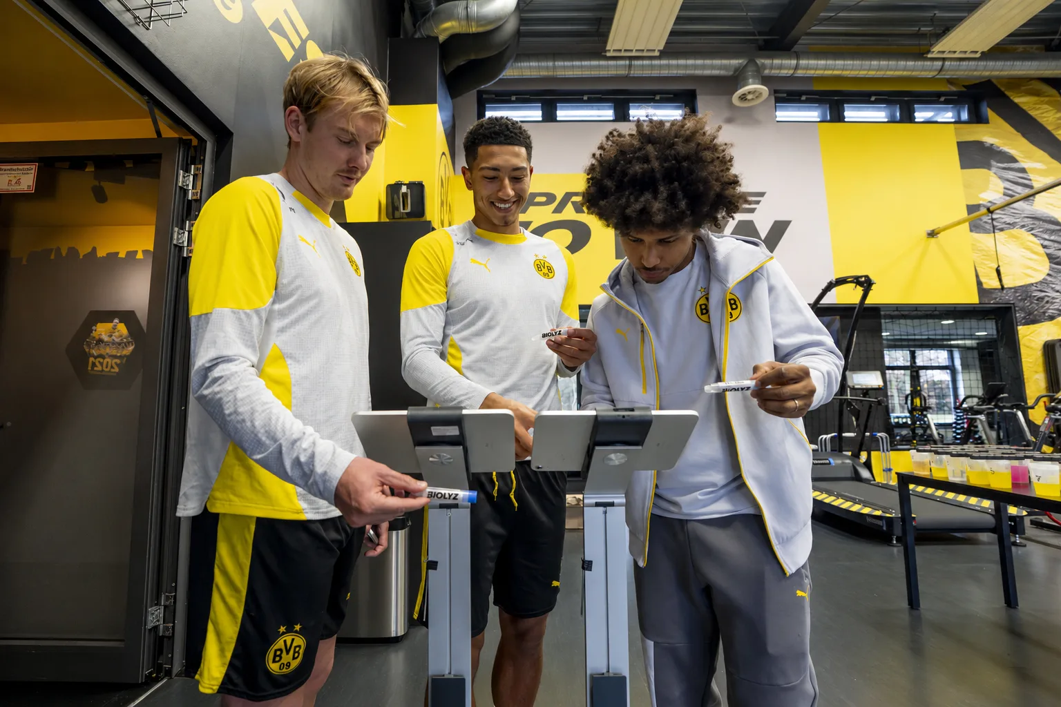 Borussia Dortmund players taking Biolyz saliva tests in the gym.